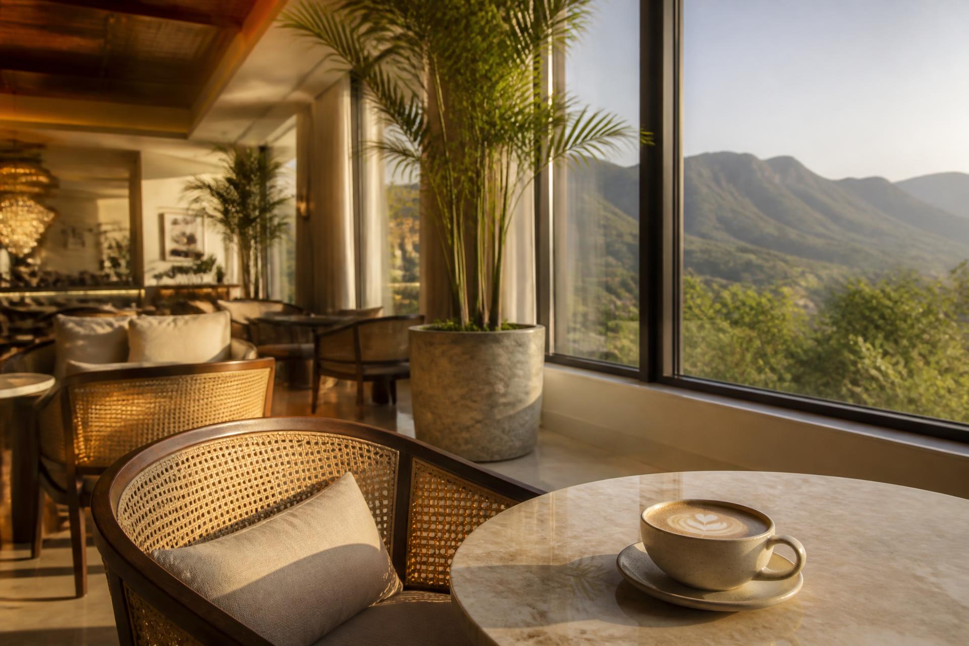 Warm Koffee Net dining room at golden hour with Margalla Hills visible through the windows