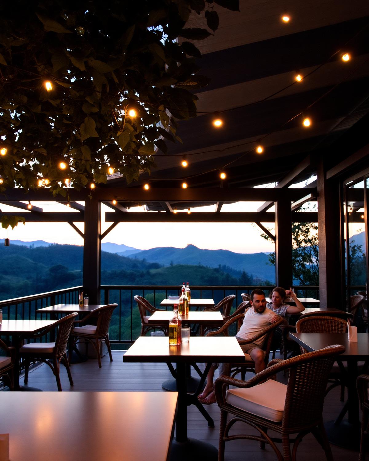 Outdoor terrace at Koffee Net with string lights and hill views at dusk